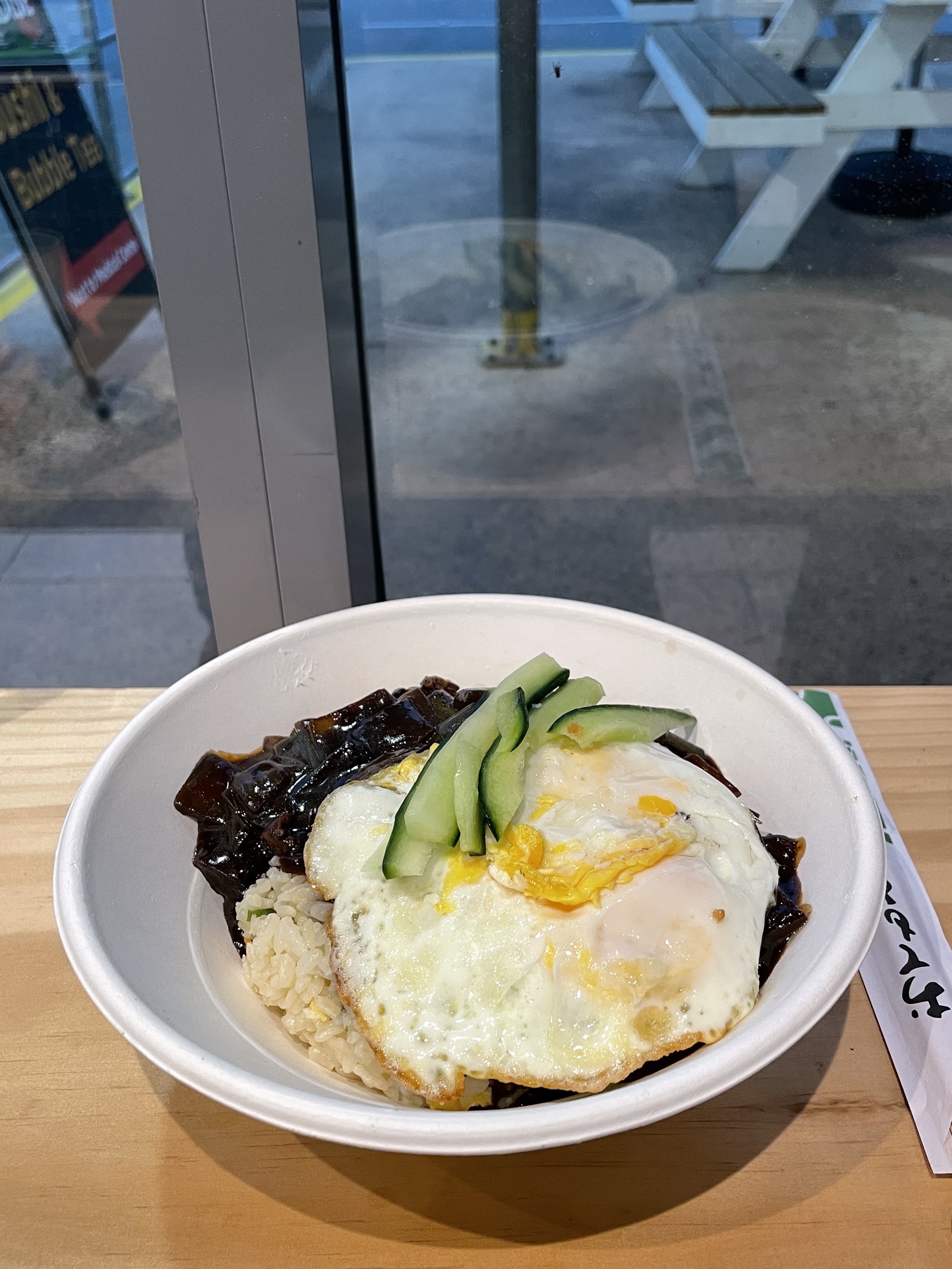 Black bean rice with a fried egg and cucumber